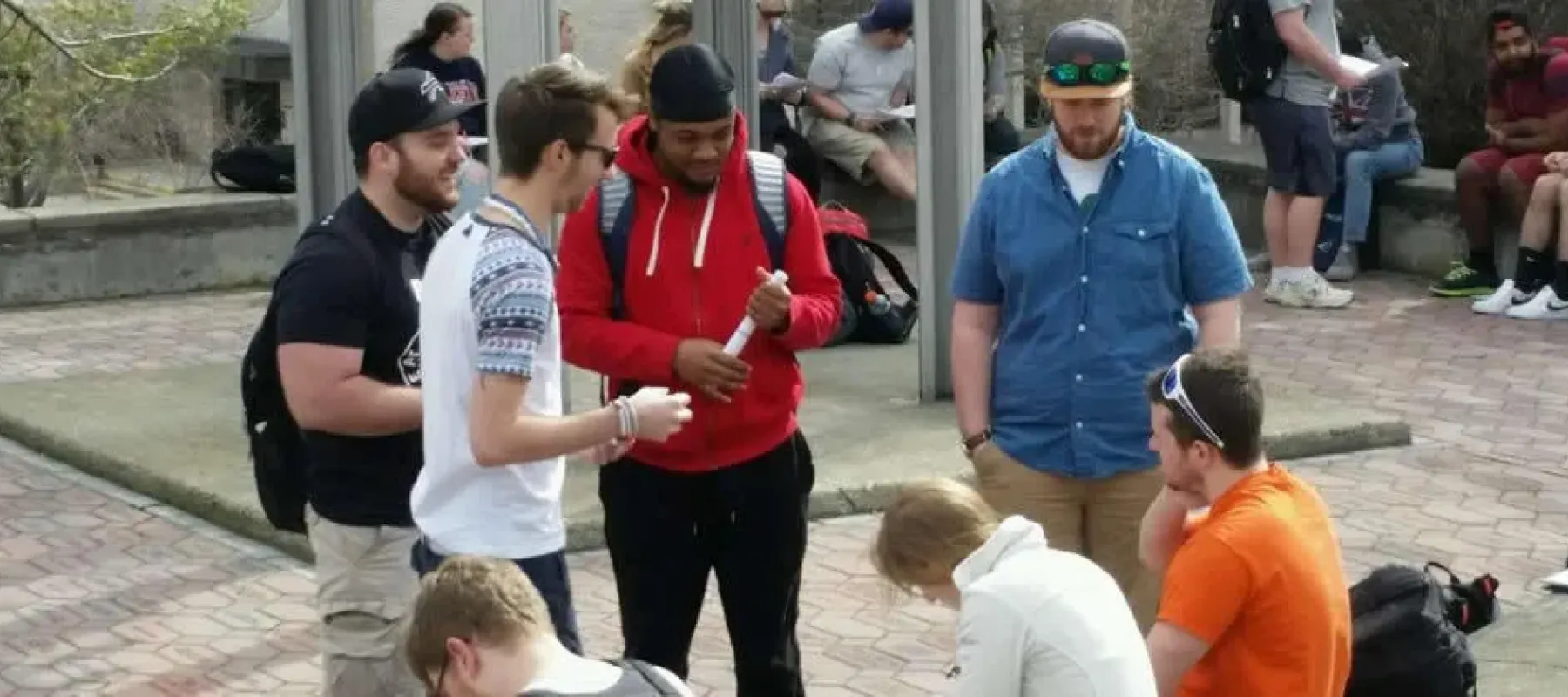 Students outside by Alfred State bell tower.