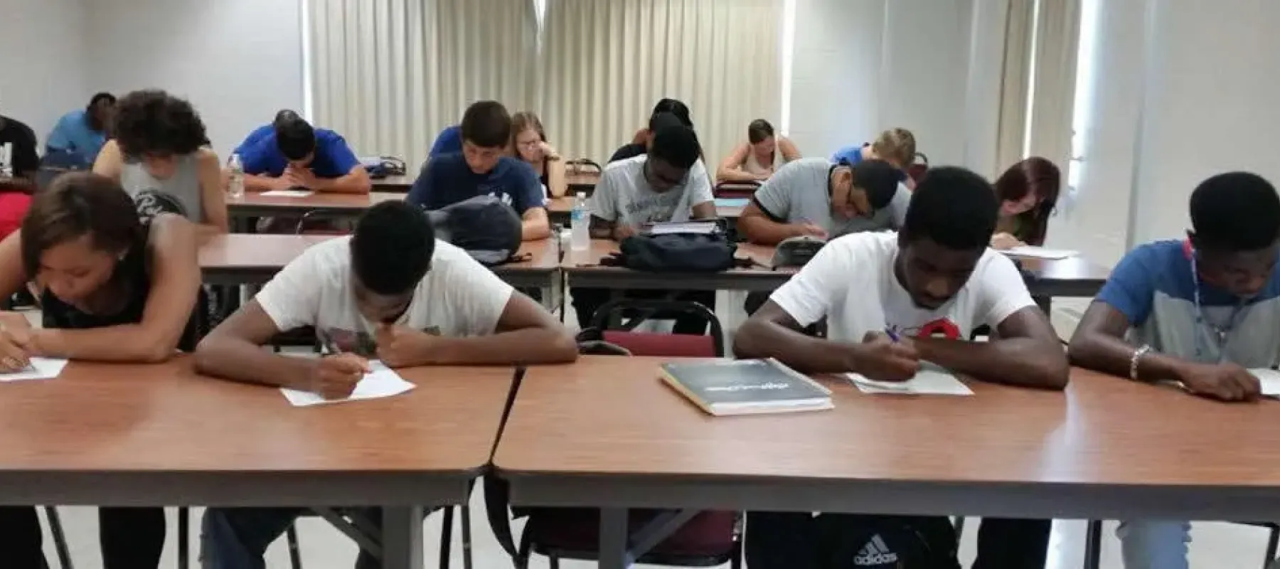 Students in classroom sitting at desks with quiz.