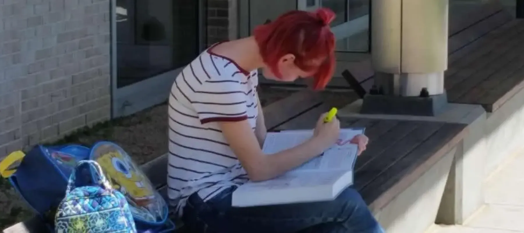 Student sitting outside studying.