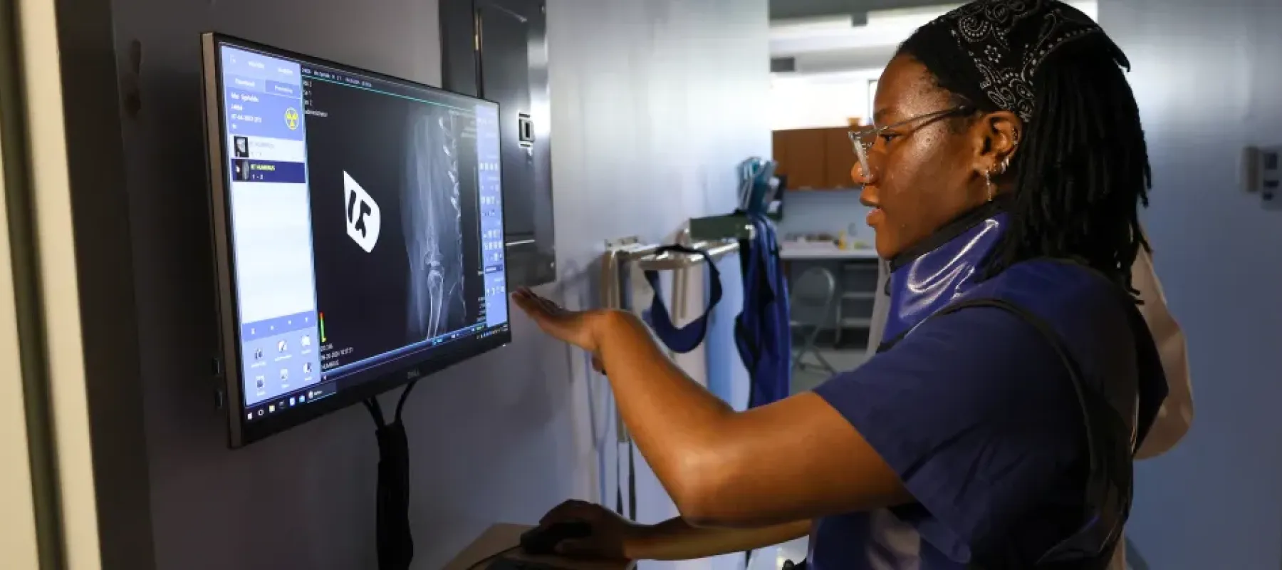 woman looking at xray on screen.