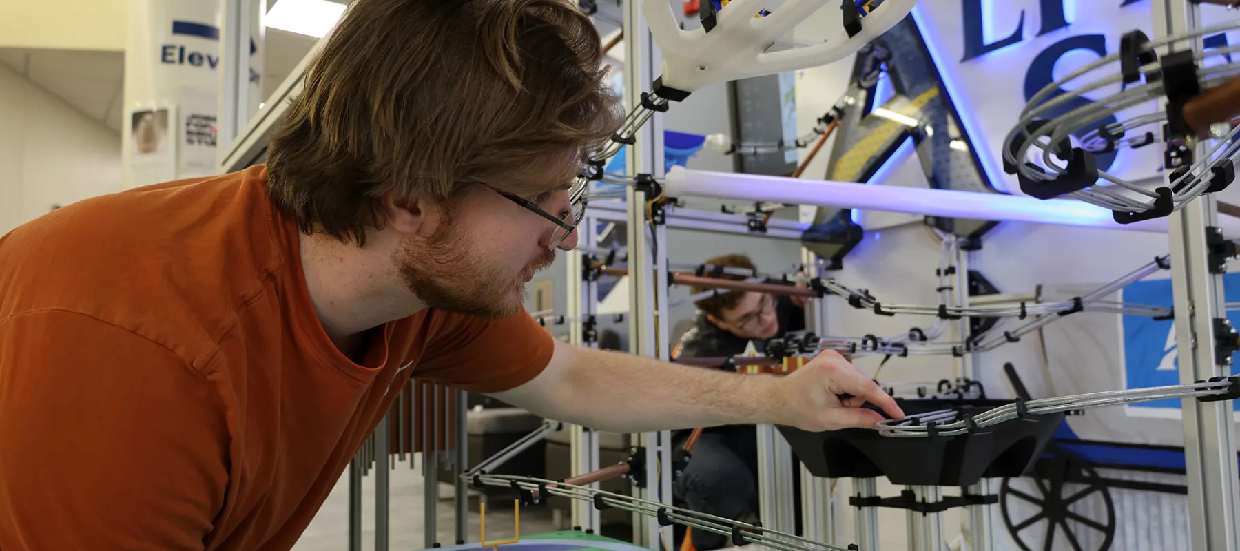 A student working on a marble machine