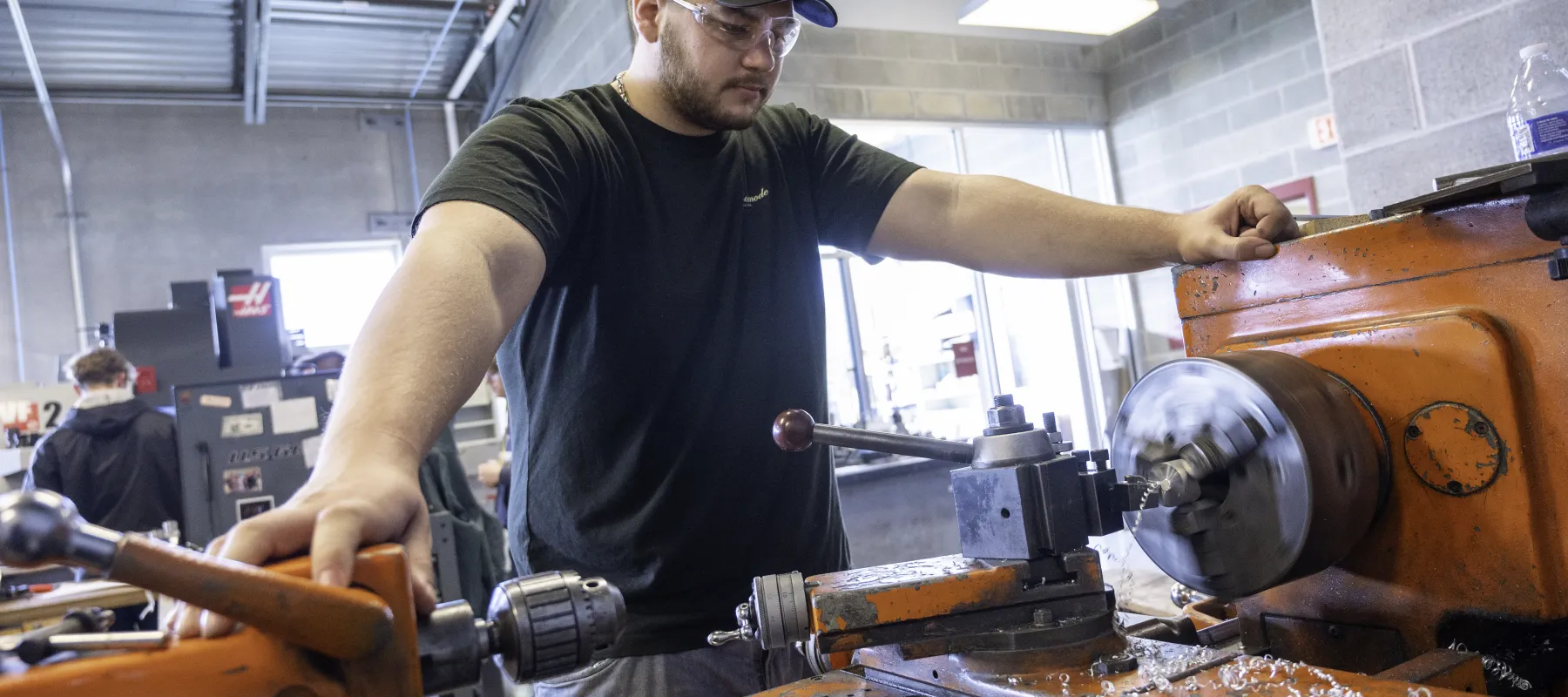 A student working on a metal lathe