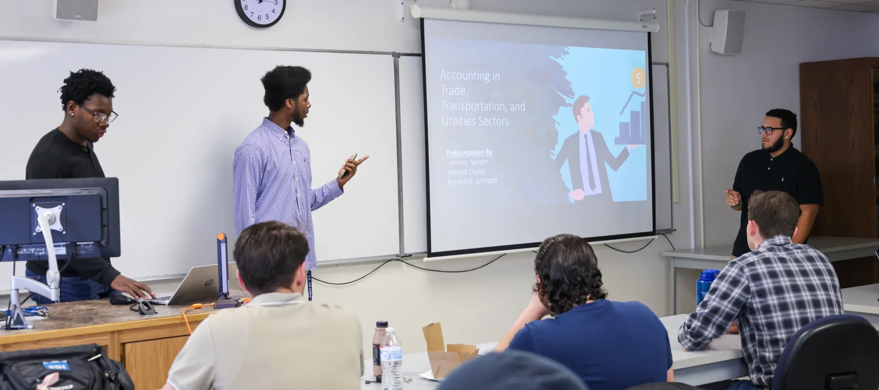 Accounting students giving a presentation to class.