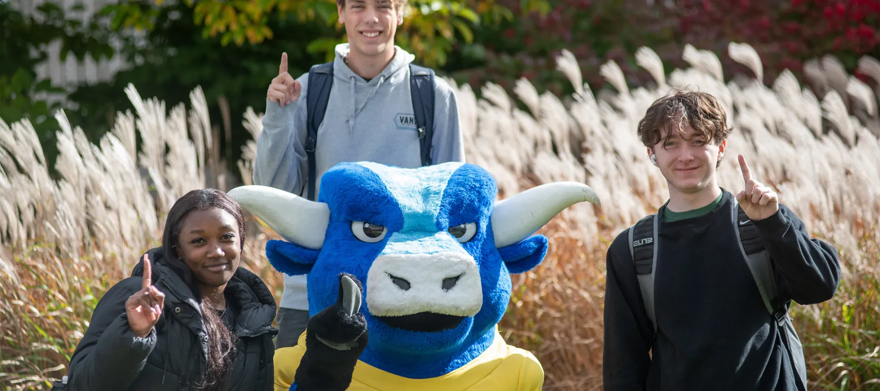 Three students posing with Big Blue.