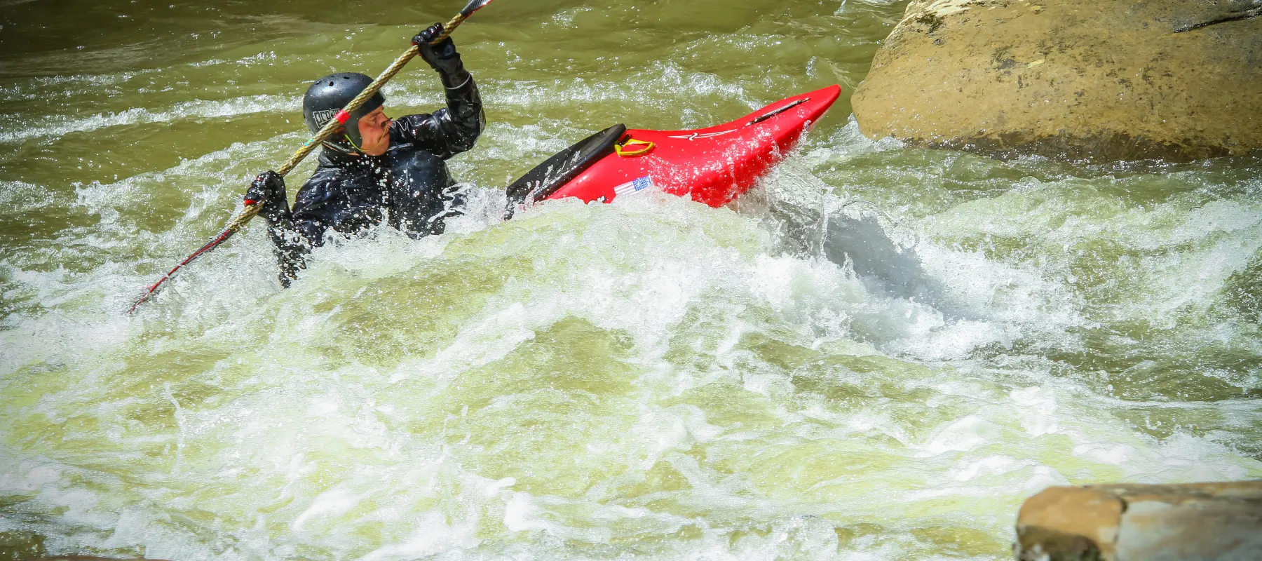 Man kayaking in river.