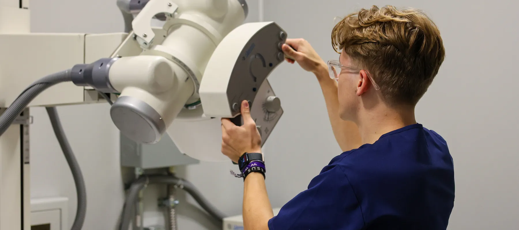 Radiologic Technology student working with equipment on campus.