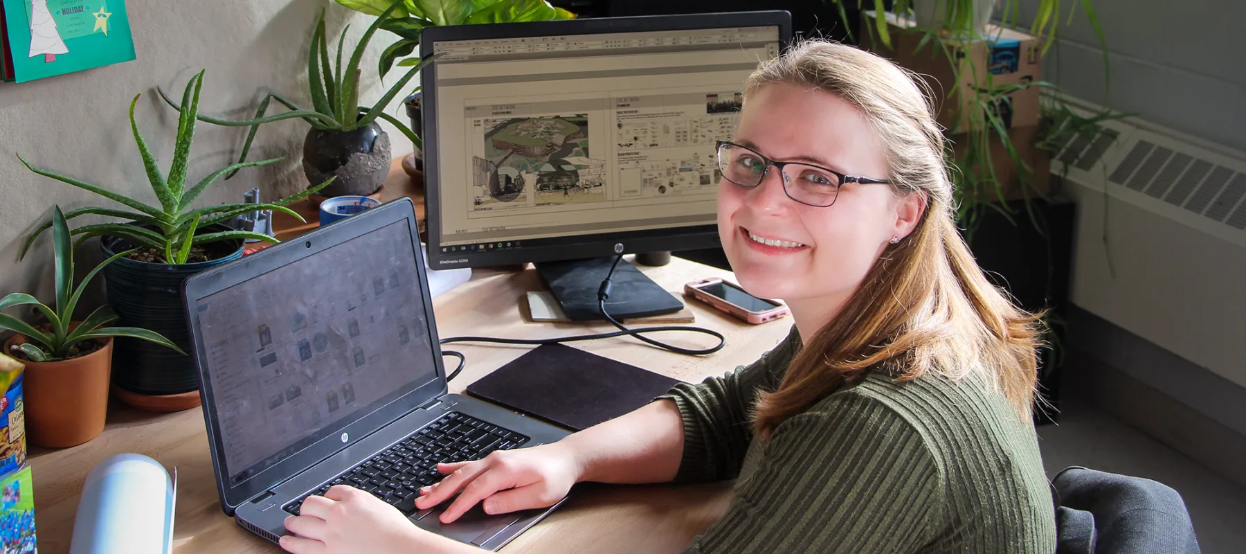 A student working on architectural designs on a computer