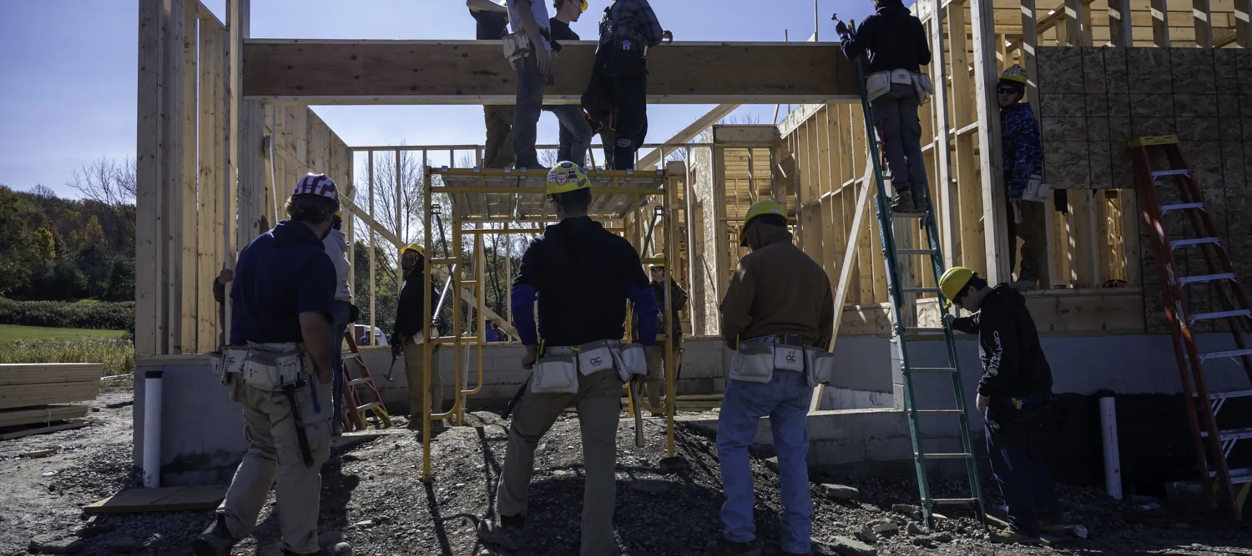 Students building a house on a construction site