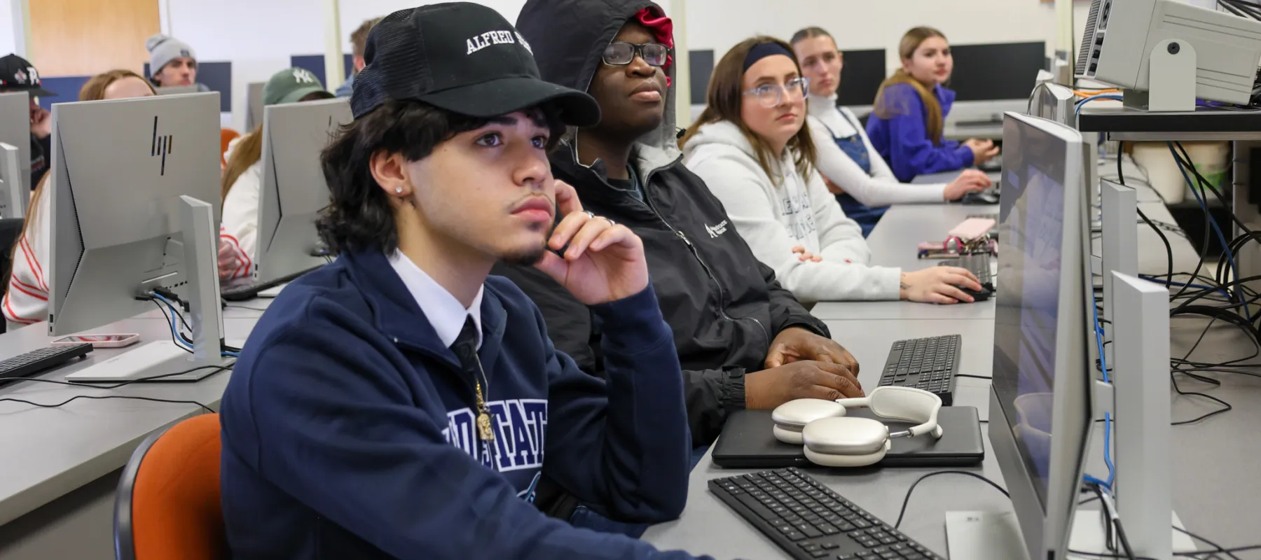 Students listening to professor in classroom.