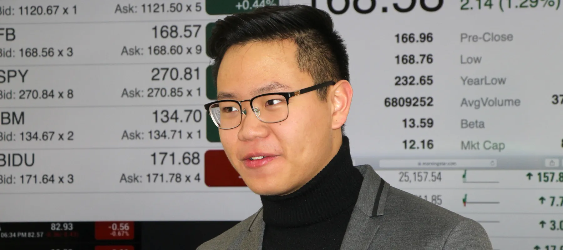 Financial planning student with stock information in the background.
