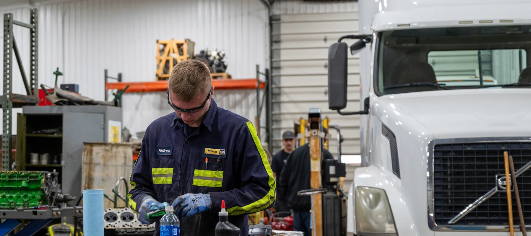 A student working in front of a truck.