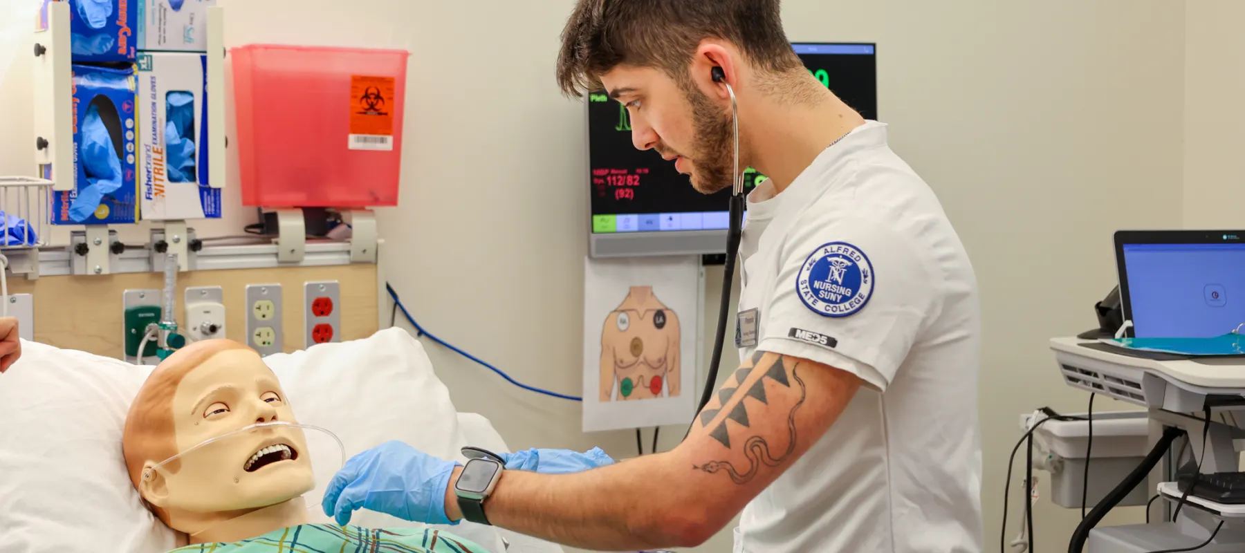 Nursing student practicing on medial manikin. 