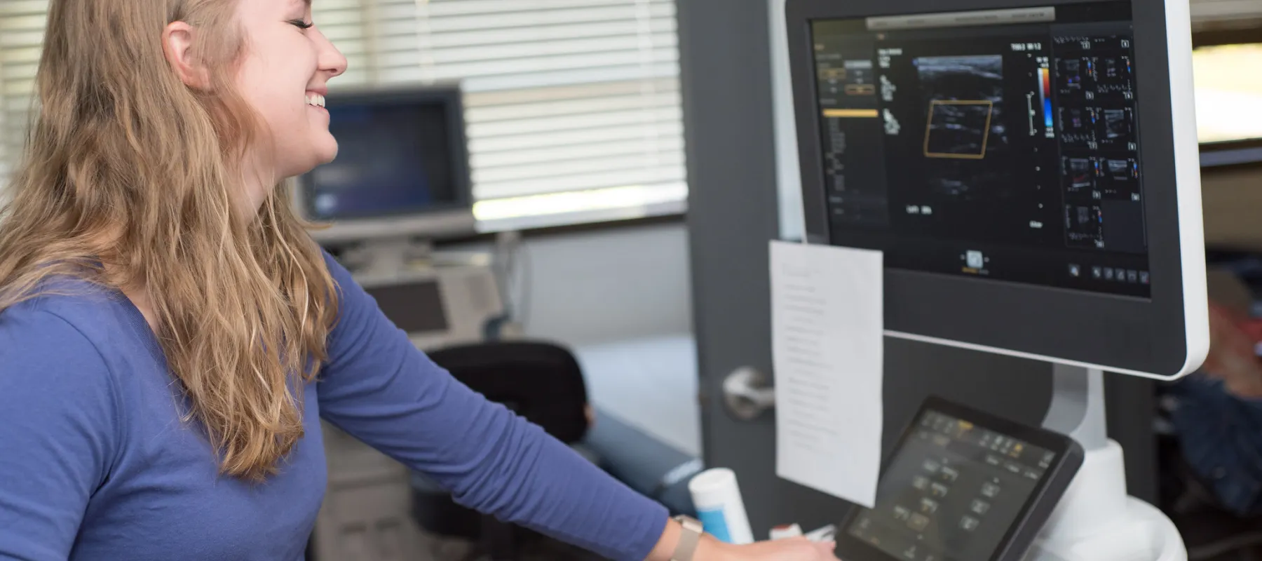 Diagnostic Medical Sonography student working with equipment in the classroom.