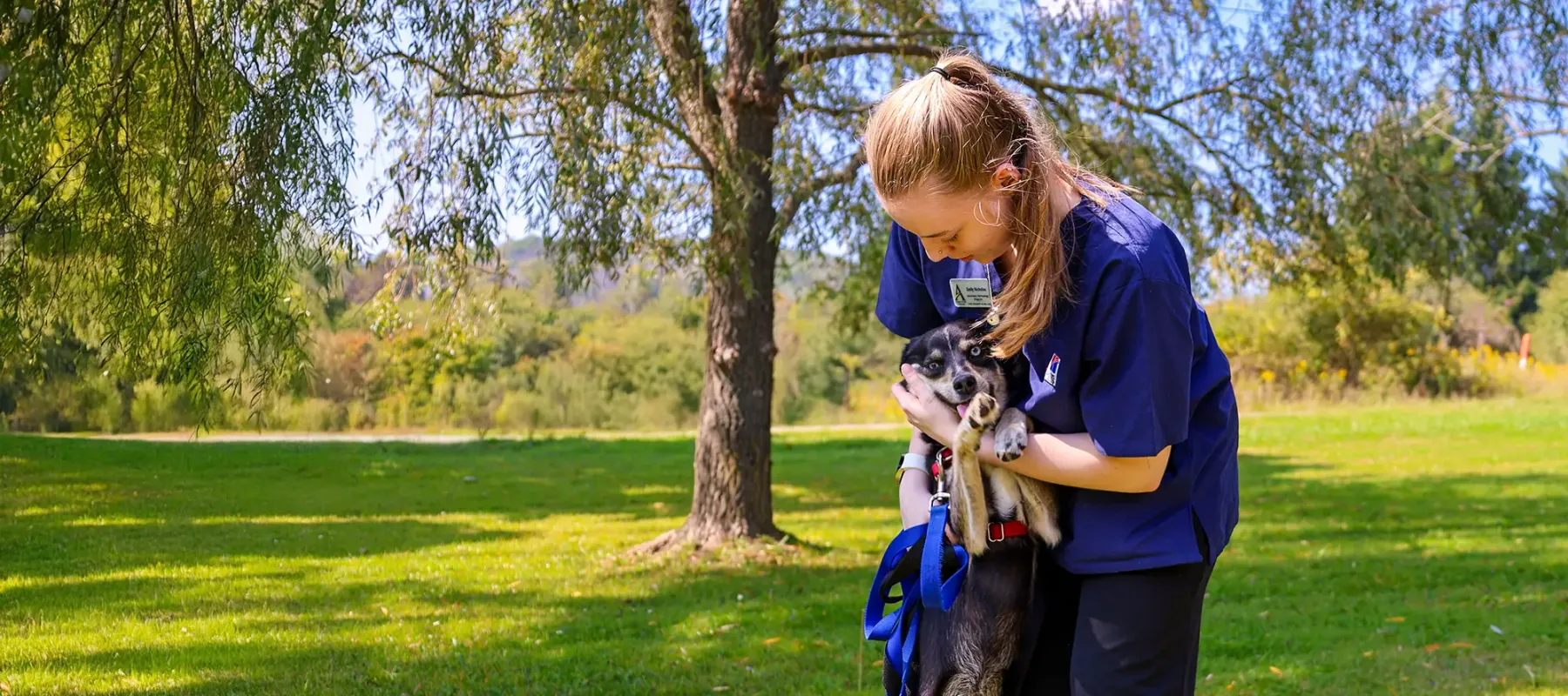 Animal Care Assistant student outside with dog.
