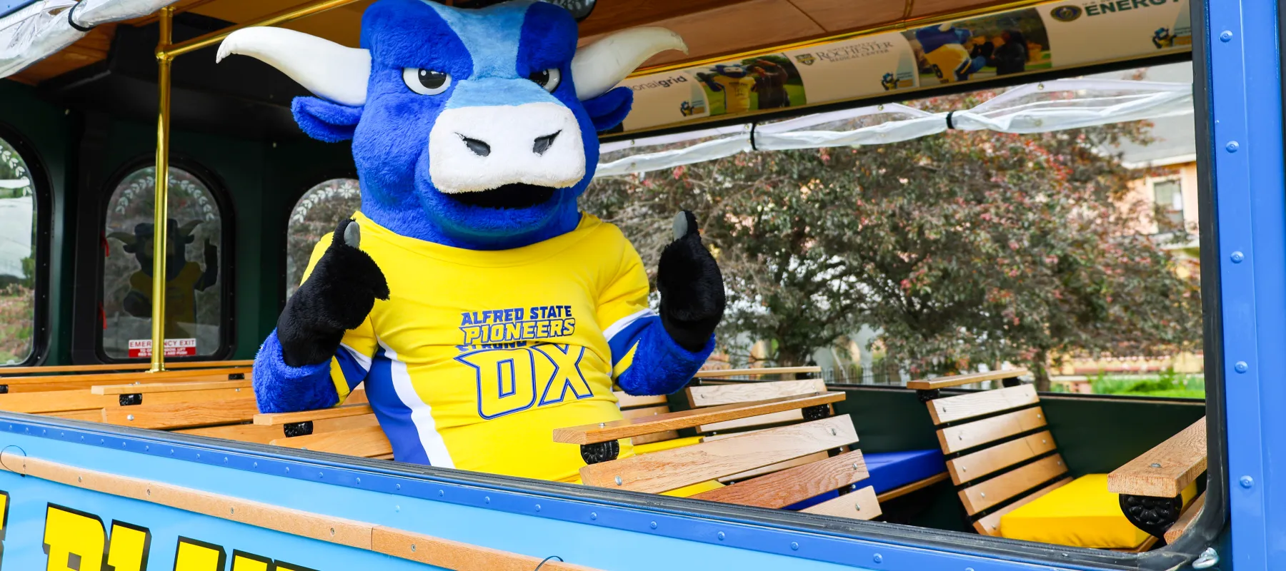 Alfred State's mascot sitting on a trolley.