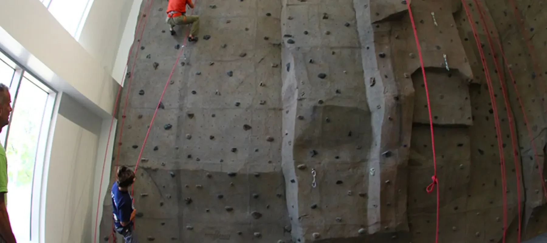 Students climbing the rock wall available in Student Leadership center.