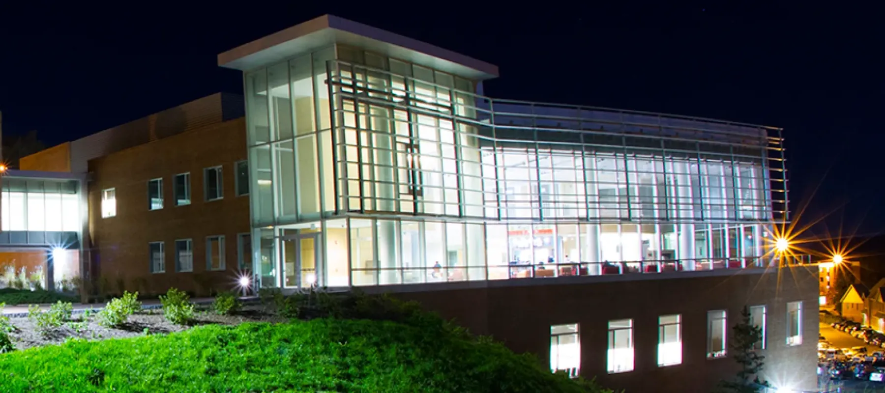 View of the Student Leadership Center from outside at night.