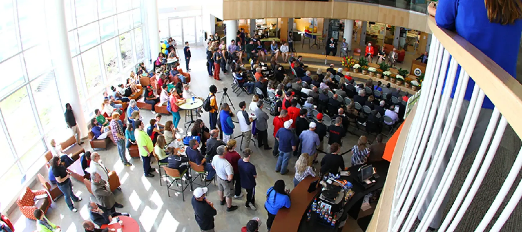 Crowd gathered in the main area of the Student Leadership Center to listen to speakers.