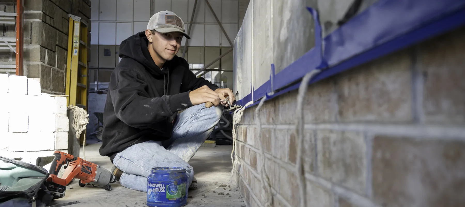 A student laying bricks