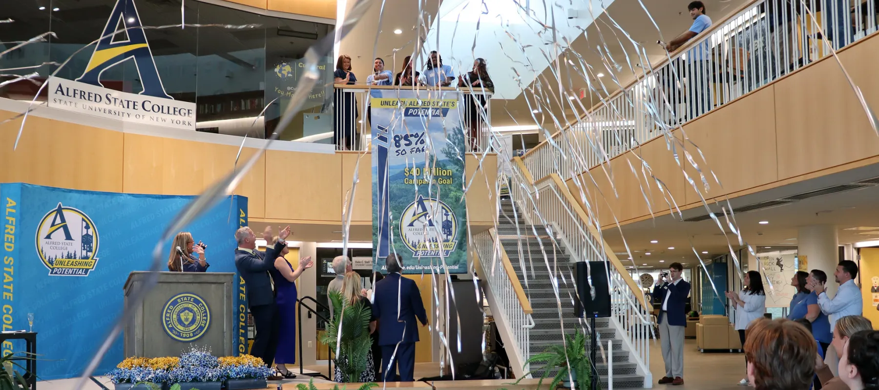 People celebrating the launch of the campaign with streamers raining from the ceiling.