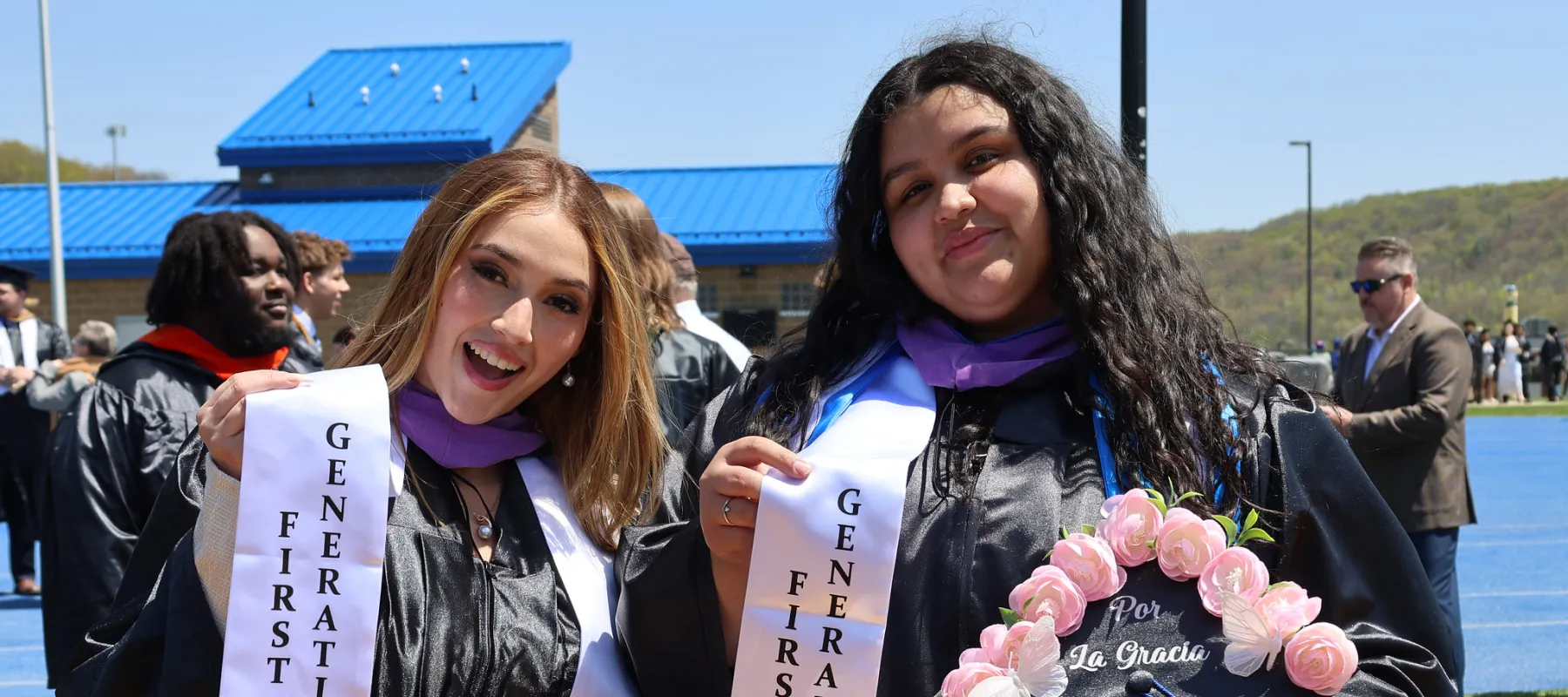 Two students in graduation caps and gowns