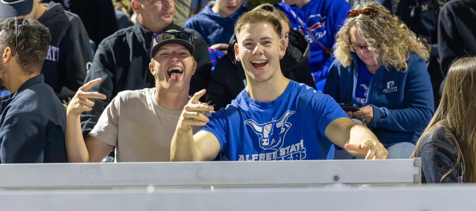 families enjoy a bonfire at homecoming