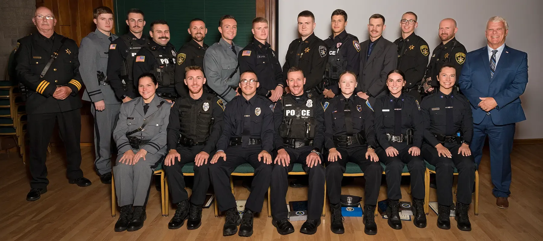 Graduates from the Police Academy posing for a group photo.