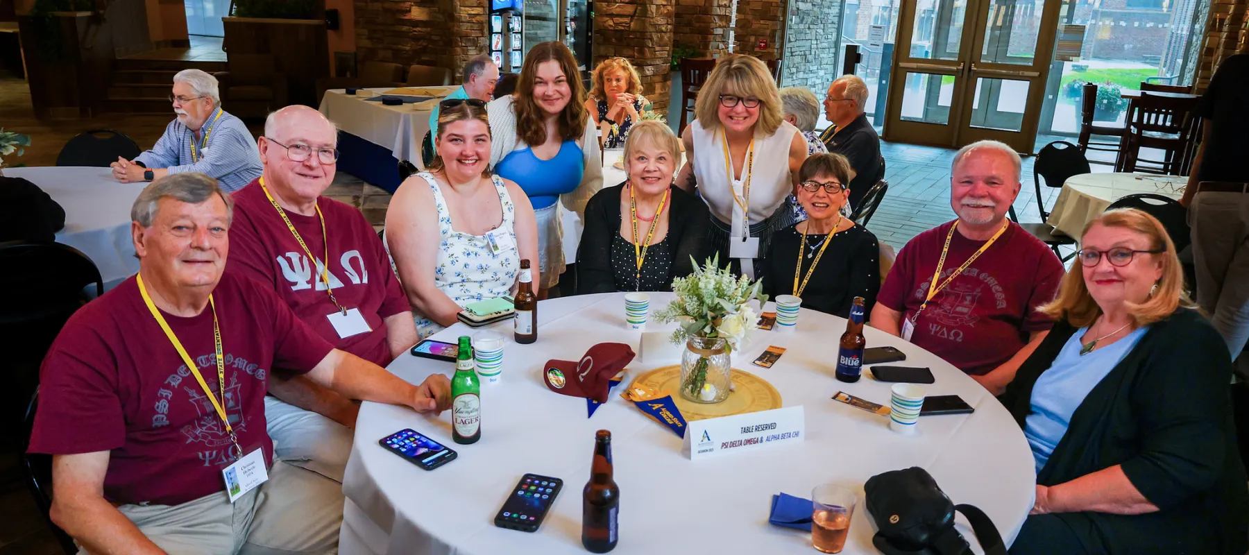 A group of Alfred State Alumni sitting around a table.