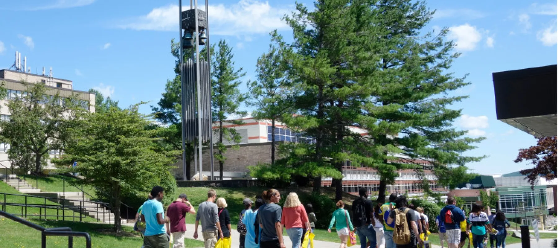 Students walk down the spine of campus by the Bell Tower.