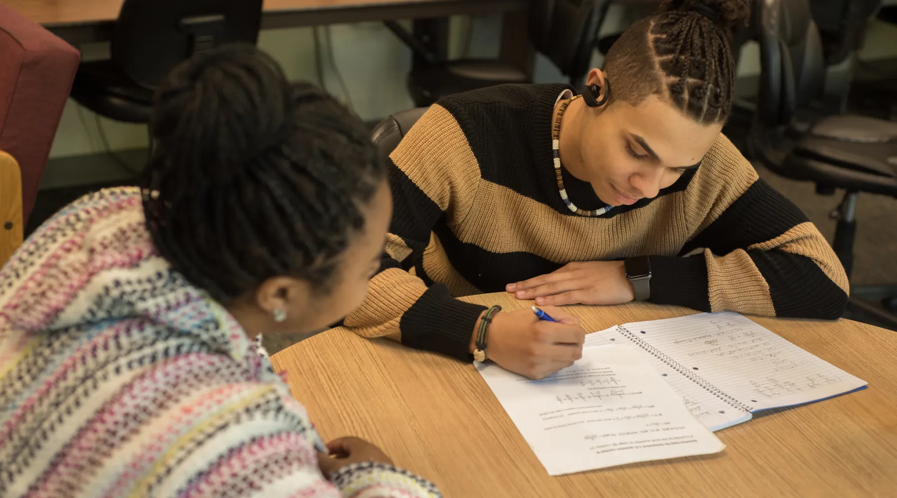 A student receiving tutoring from a professor.