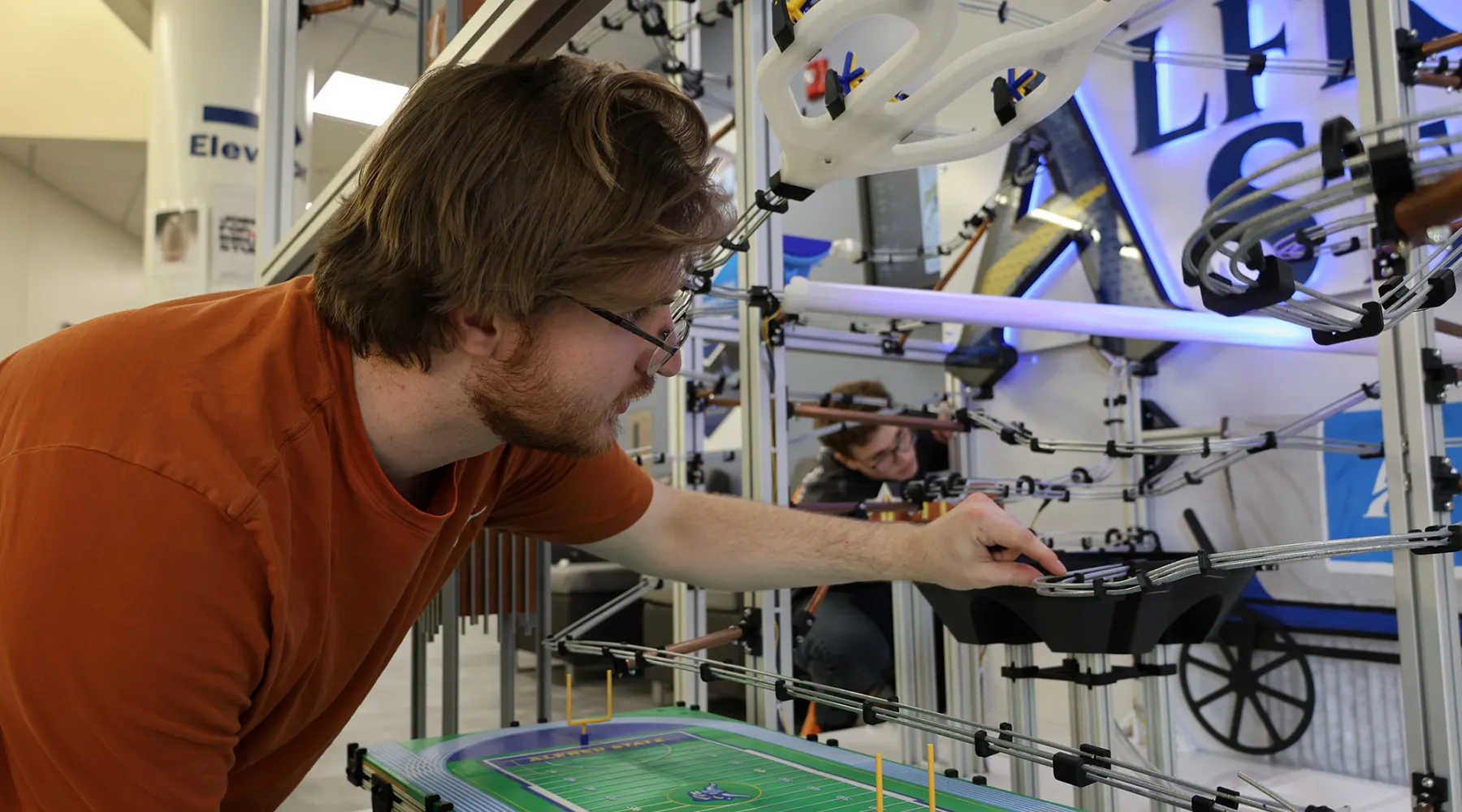 A student working on a marble machine