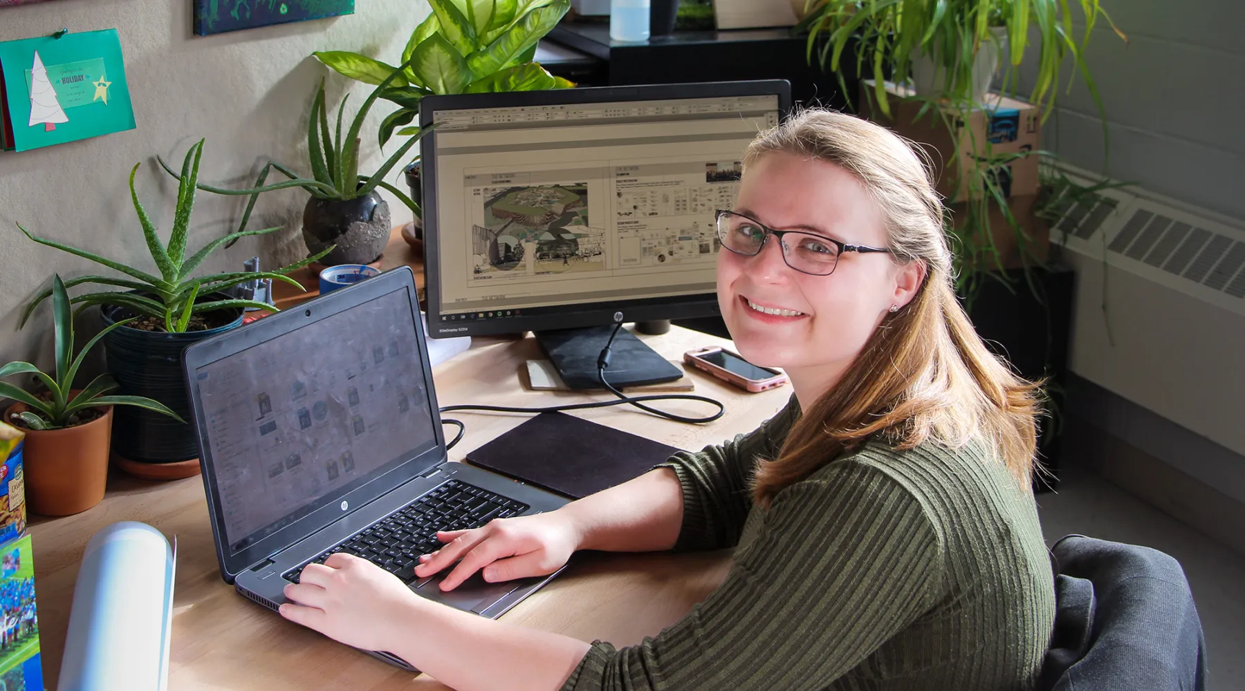 A student working on architectural designs on a computer