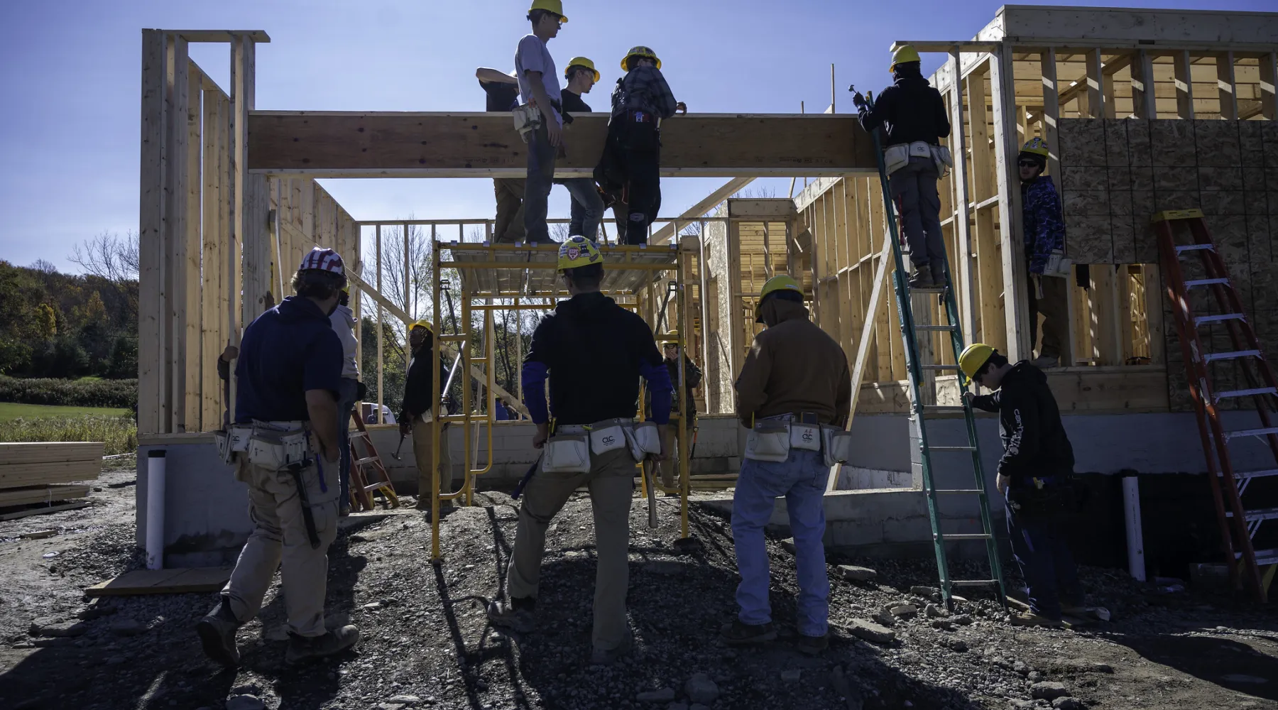 Students building a house on a construction site