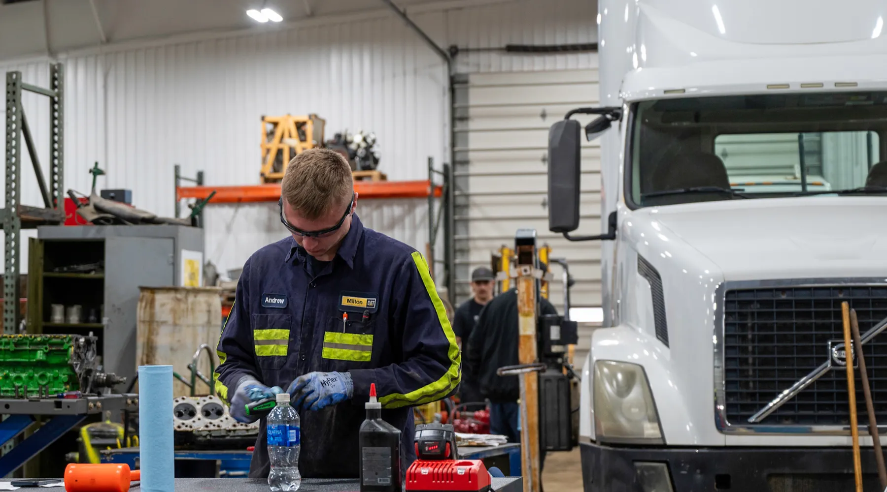 A student working in front of a truck.