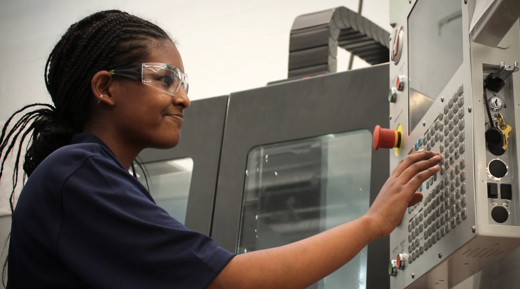 A student working on a machine.