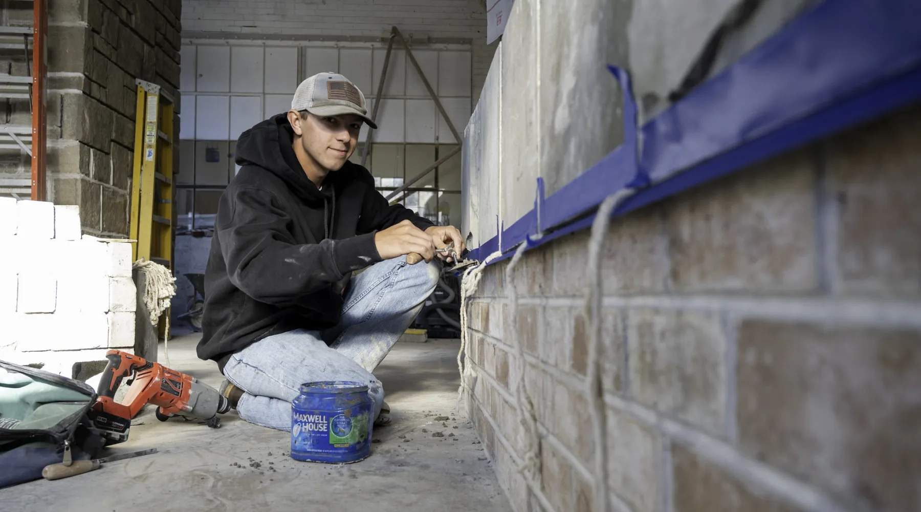 A student laying bricks