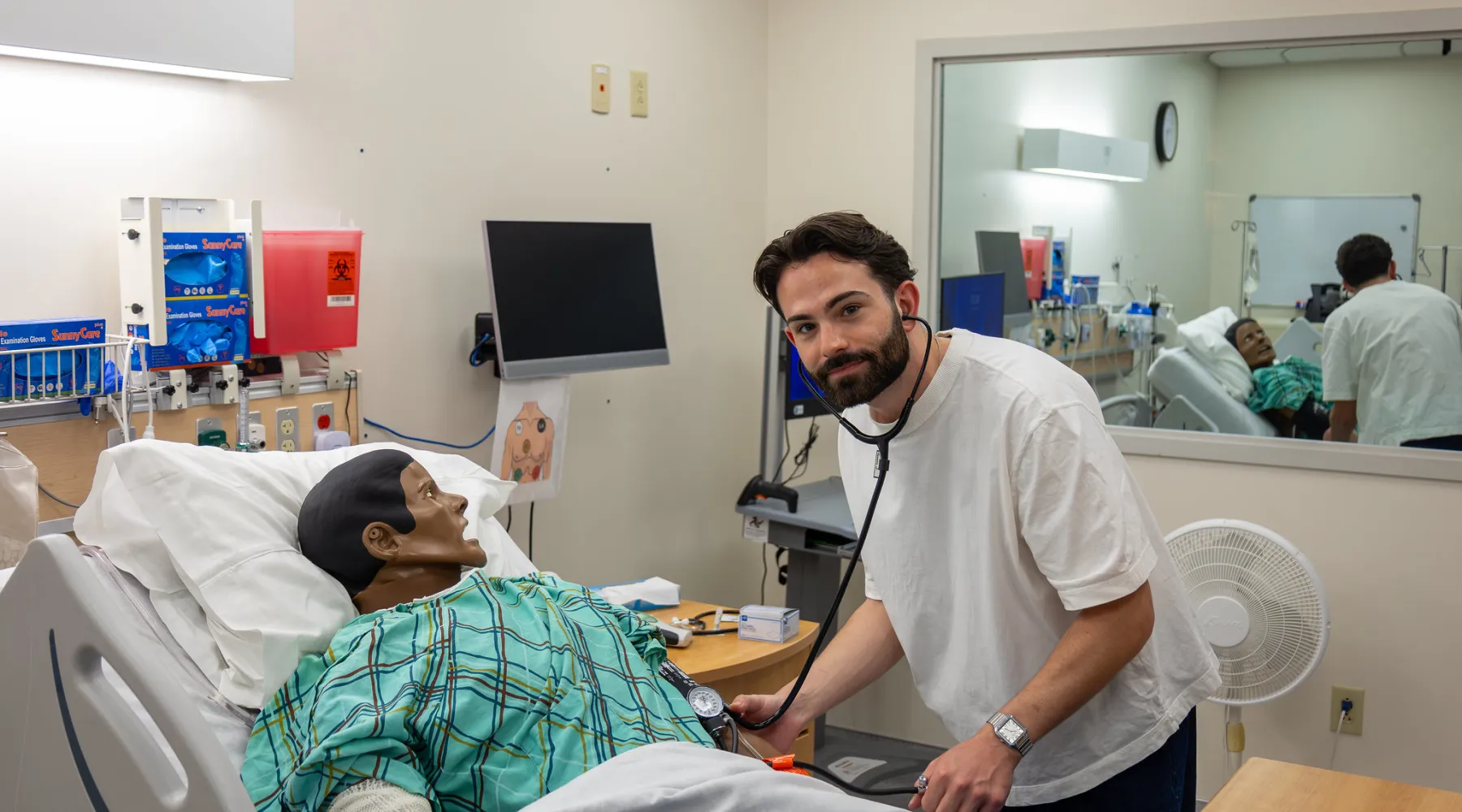 A student practicing care for a manikin