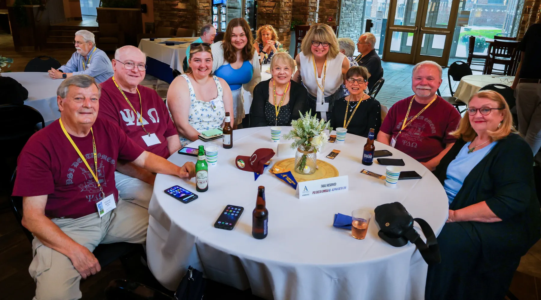 A group of Alfred State Alumni sitting around a table.
