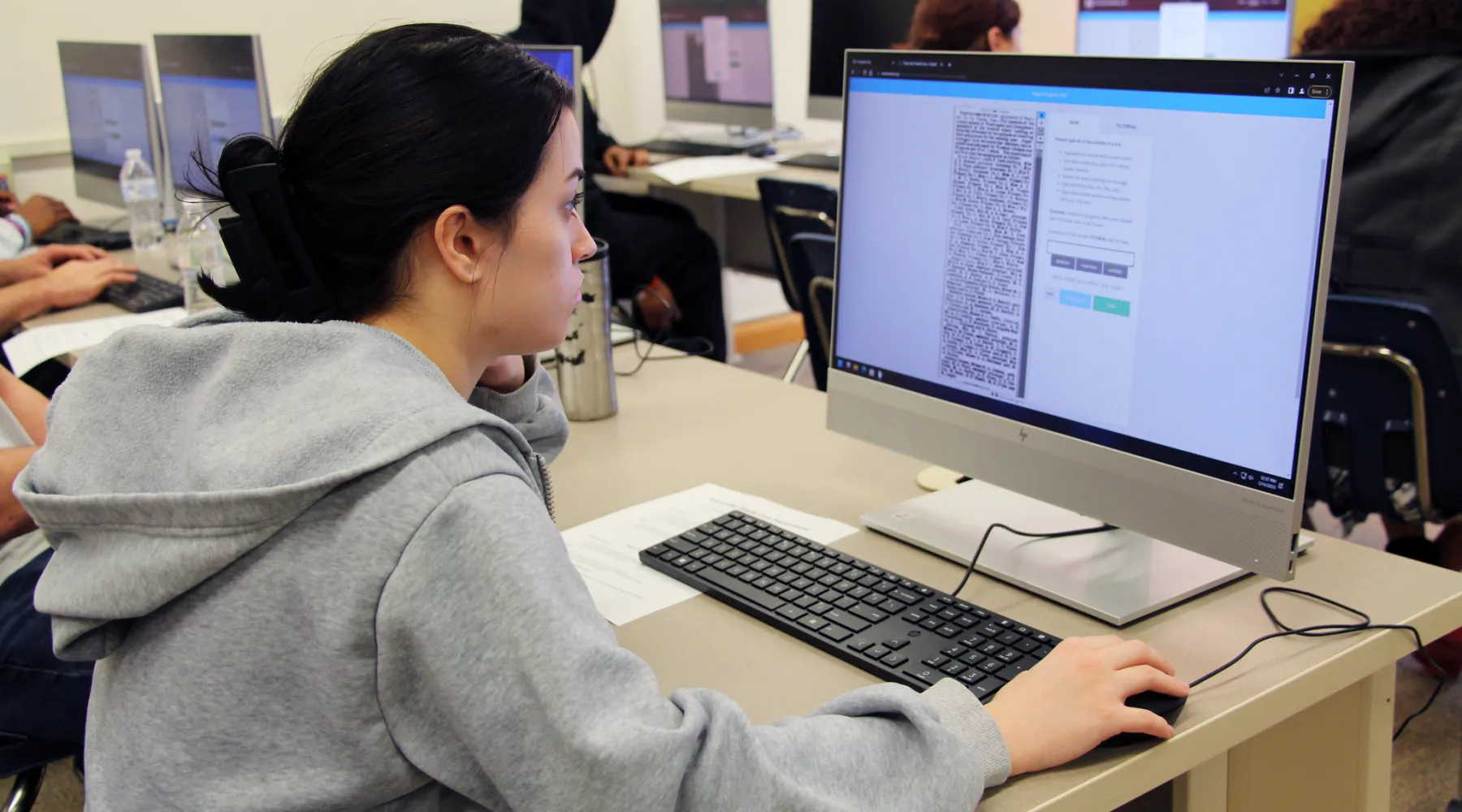 A student reviewing a reading on a computer.